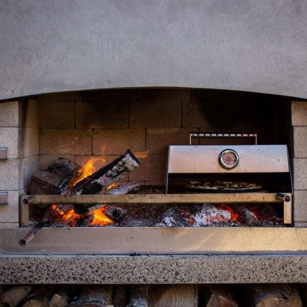 Cooking pizza with cooking accessories on Flare Outdoor Fire