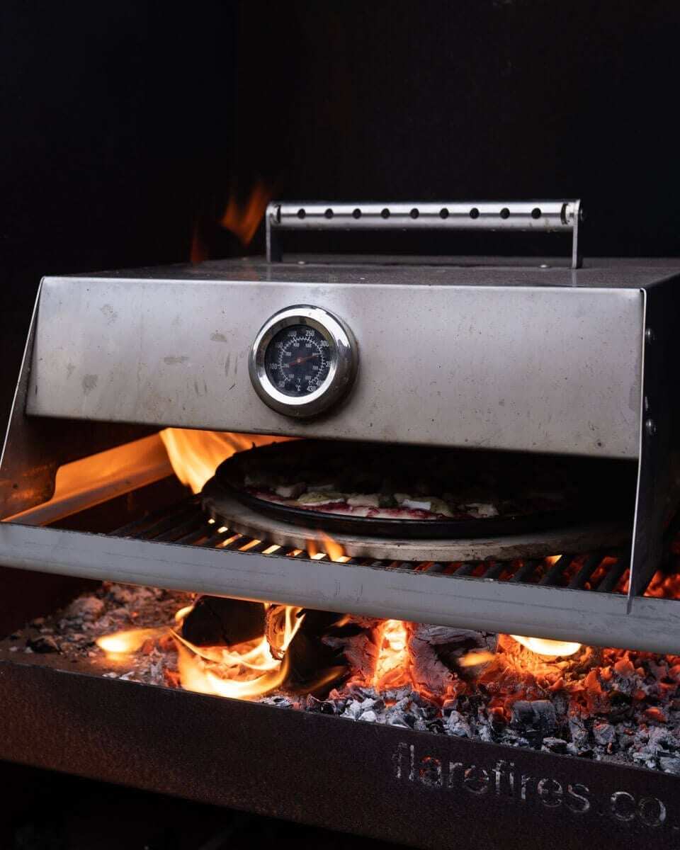 Cooking pizza on a Flare Martello Outdoor Fireplace