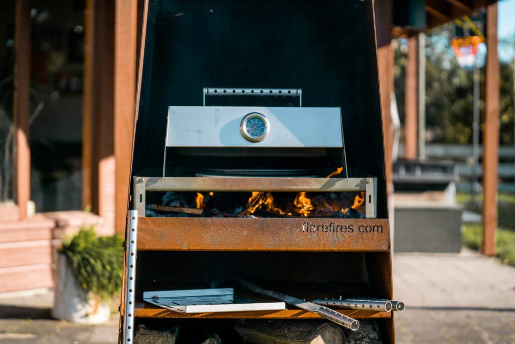 Cooking pizza on a Martello Outdoor Fireplace